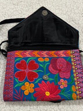 Small embroidered purse with floral pattern design.